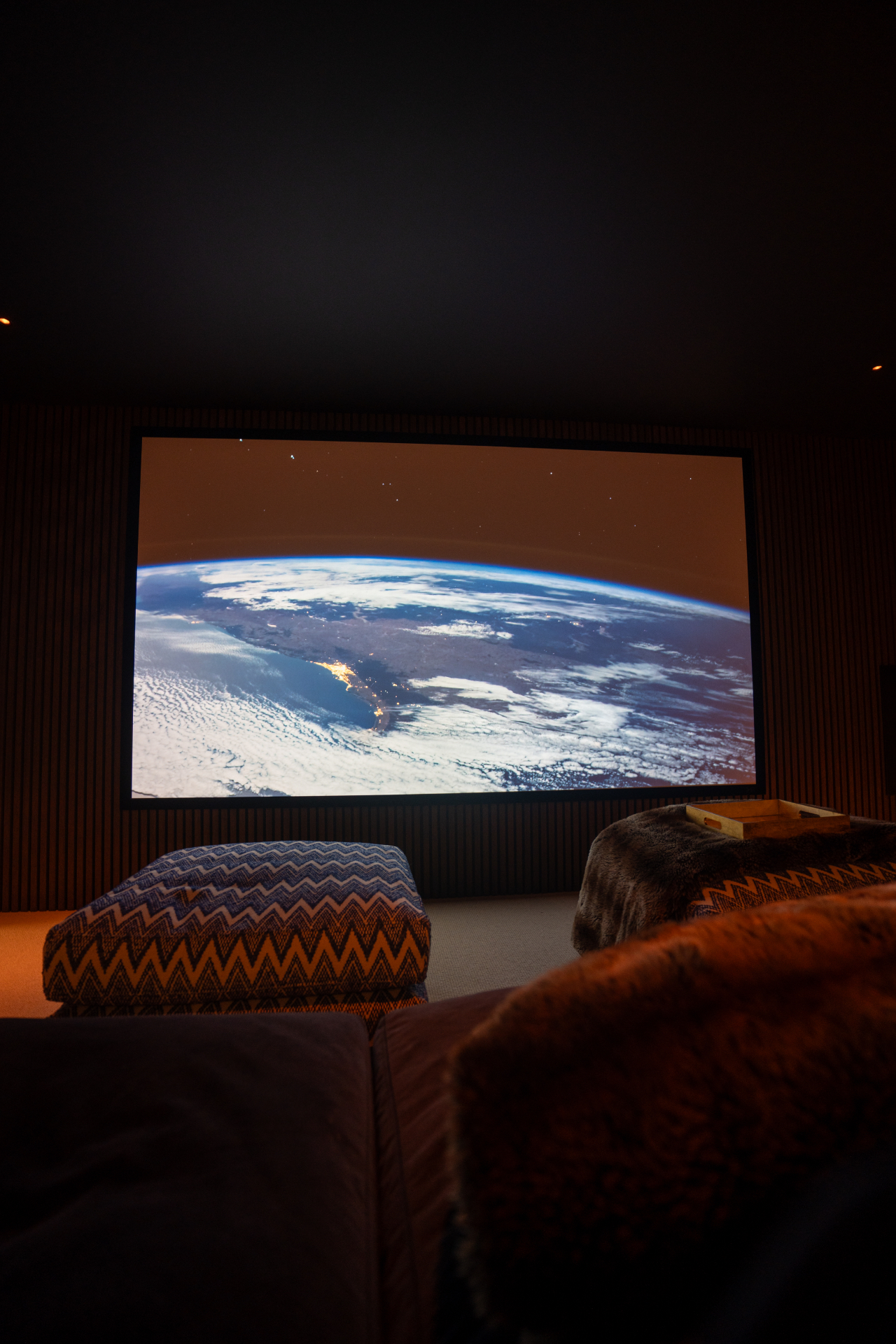 The Surrey cinema in darkness with the projector showing a film