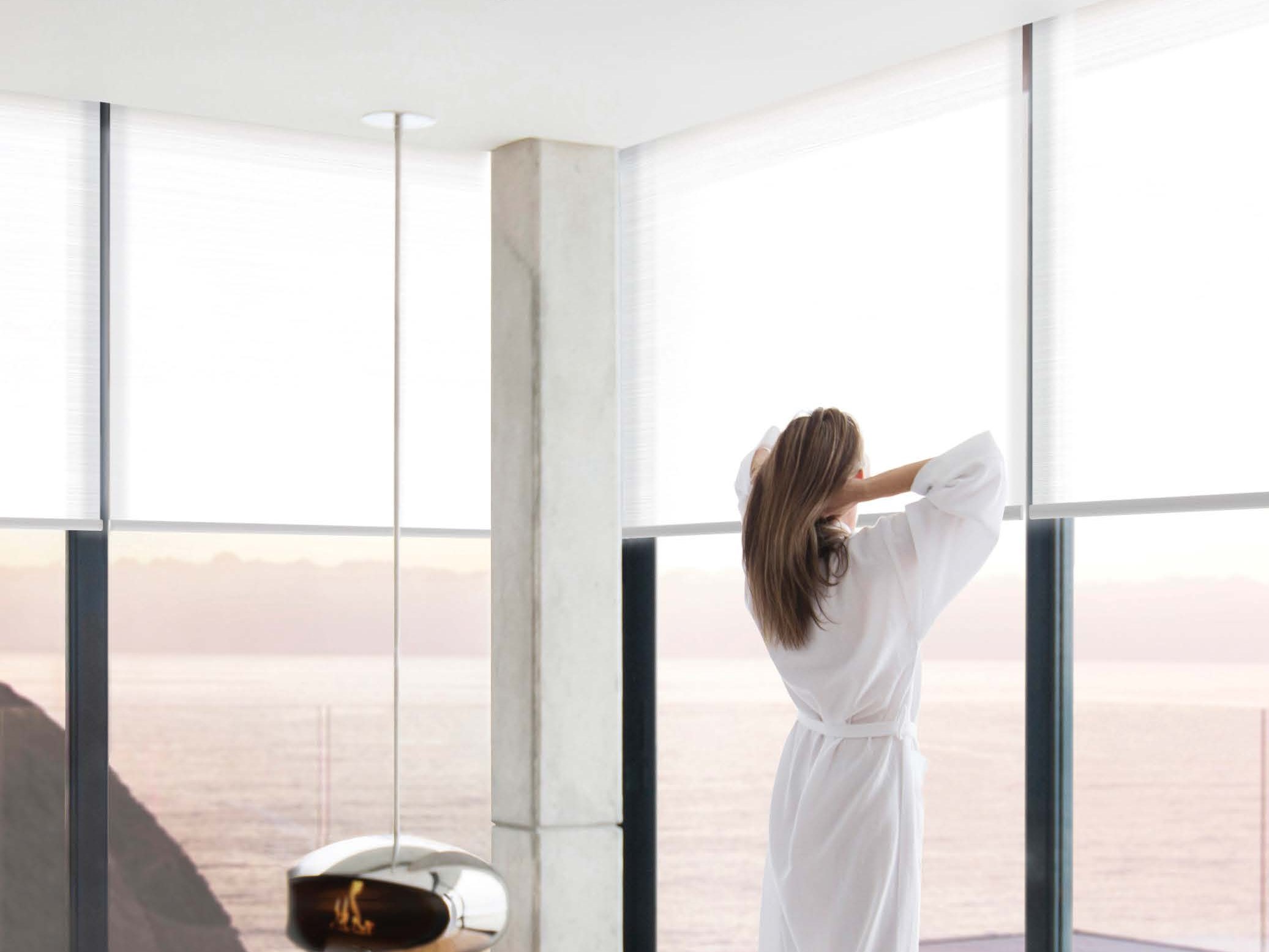 Automated Lutron roller shades in a luxury bedroom — Lutron lifestyle photography
